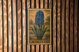 A framed illustration of a blue hyacinth flower is displayed on a wooden wall.