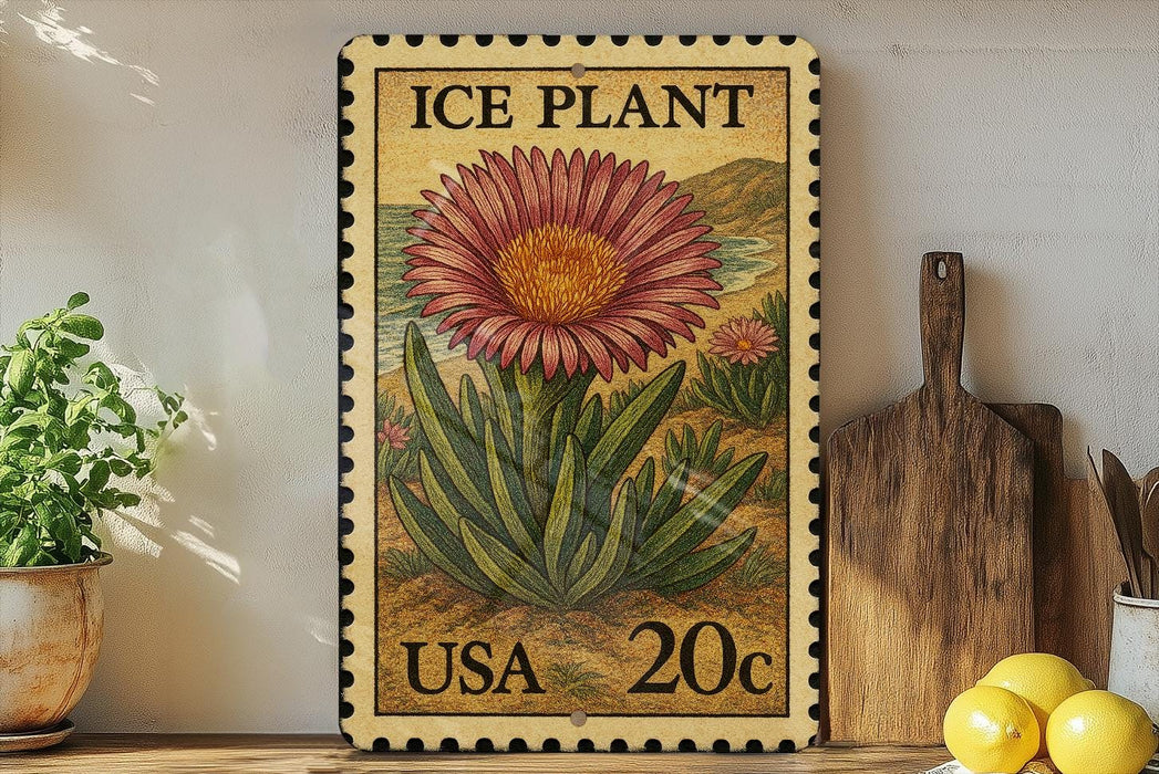A framed postage stamp featuring an illustration of a large pink flower, with the text "ICE PLANT" and "USA 20c" printed on it. The stamp is displayed on a shelf next to a potted plant, a wooden cutting board, and some lemons.