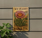 A wooden sign with a large flower image and text, mounted on a wall.