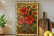 A framed illustration of red flowers on a wooden surface, with a potted plant to the left and a wooden cutting board to the right.