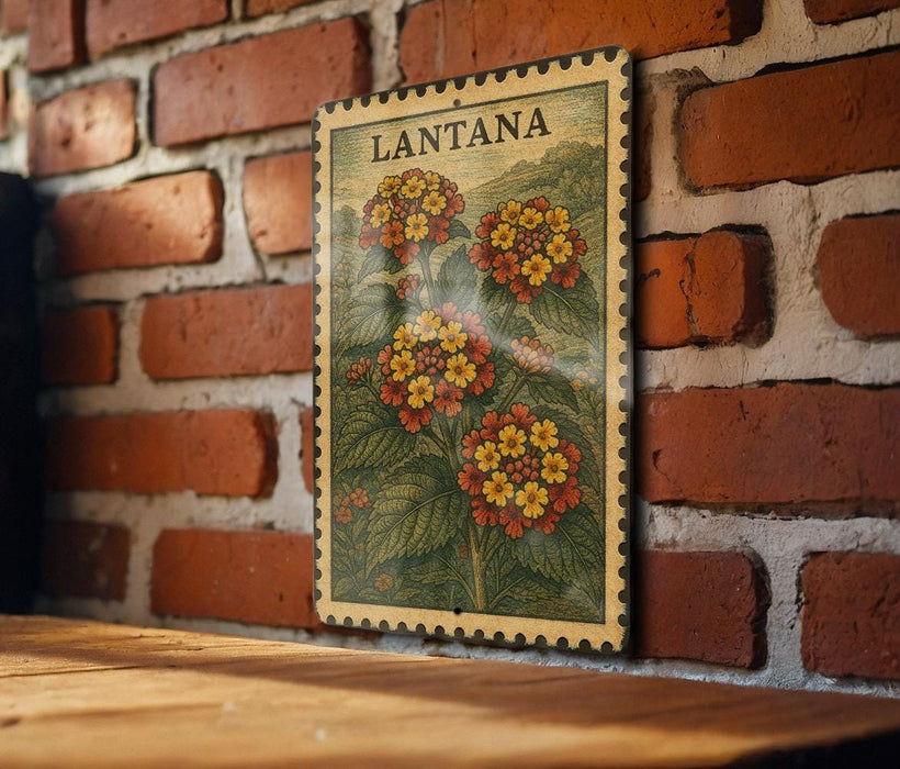 A framed vintage postage stamp depicting a vibrant floral scene is displayed on a brick wall.