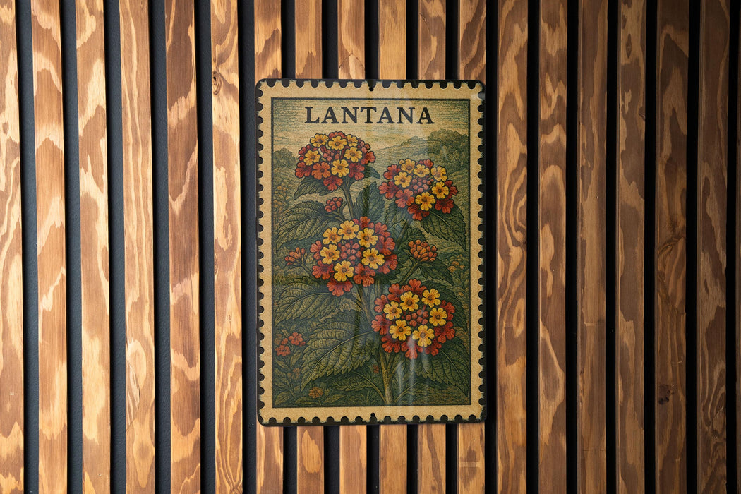 A framed vintage postage stamp featuring a floral illustration of Lantana flowers is displayed on a wooden wall.
