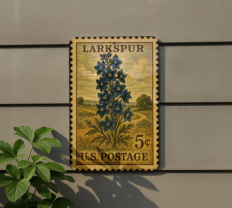A vintage postage stamp from the United States, featuring a blue flower on a yellow background, mounted on a wall.