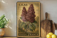 A vintage-style metal sign with a floral illustration of lilies, mounted on a wall next to a wooden cutting board and a potted plant.