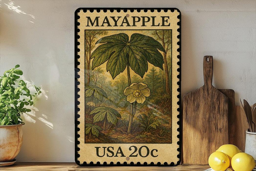 A framed stamp depicting a plant with a large leaf and a flower, placed on a shelf next to a wooden cutting board and some lemons.