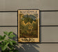 A framed image of a plant with a yellow flower, mounted on a wall.