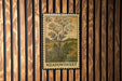 A vintage-style postage stamp featuring a meadow sweet plant is displayed on a wooden wall.