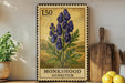 A framed illustration of a blue flower on a wooden shelf, with a kitchen-themed background and a wooden cutting board to the right.
