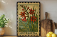 A framed illustration of red flowers is displayed on a shelf, accompanied by a wooden cutting board and a potted plant.