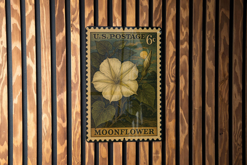 A U.S. postage stamp featuring a yellow flower is displayed on a wooden wall.