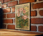A vintage-style postage stamp featuring a floral illustration of a mountain laurel plant, mounted on a brick wall.