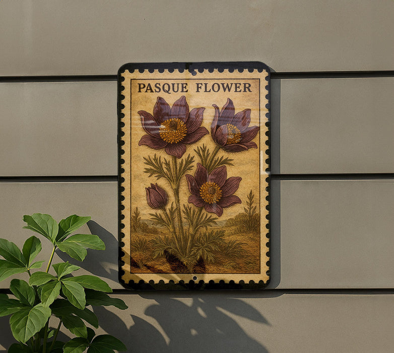a decorative sign with a floral design, mounted on a wall next to a plant.