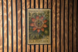A vintage U.S. postage stamp featuring a vibrant illustration of a passion flower, mounted on a wooden wall.