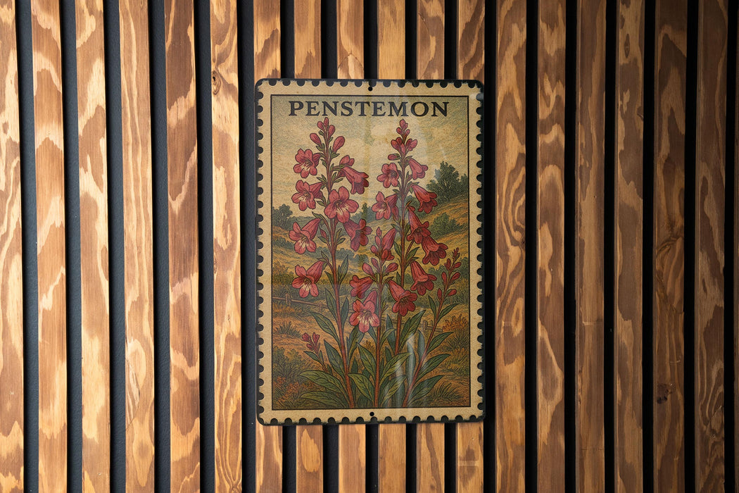 A framed print of a penstemon flower is displayed on a wooden wall.