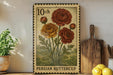 A vintage-style metal stamp with a floral design, featuring a Persian buttercup flower, is displayed on a shelf next to a wooden cutting board and some potted plants.