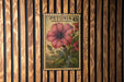 A vintage-style postage stamp from Petunia, featuring a large pink hibiscus flower and green leaves, is displayed on a wooden wall.