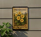 a postage stamp with a floral design, mounted on a wall next to a plant.