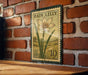 A vintage-style postage stamp featuring a lily flower is displayed on a brick wall.