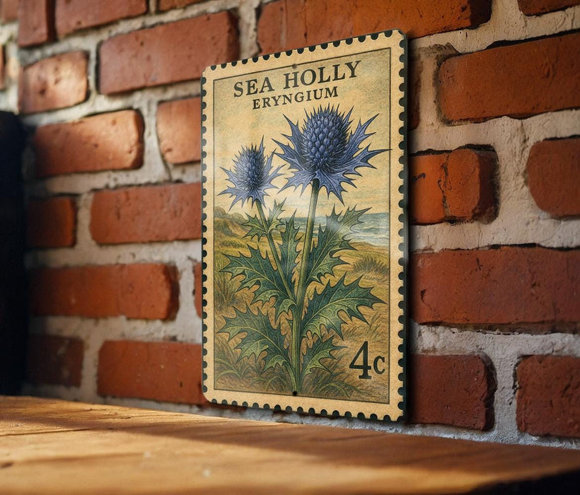 A vintage postage stamp featuring a blue thistle flower is displayed on a brick wall.