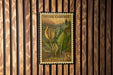 A vintage US postage stamp featuring a skunk cabbage plant, mounted on a wooden wall.