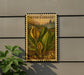 A vintage-style postage stamp featuring skunk cabbage plants is displayed on a wall, with a plant in the foreground.
