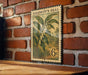 A vintage-style postage stamp featuring a plant with green leaves and yellow flowers, mounted on a brick wall.