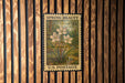 A vintage U.S. postage stamp featuring a floral design is displayed on a wooden wall.