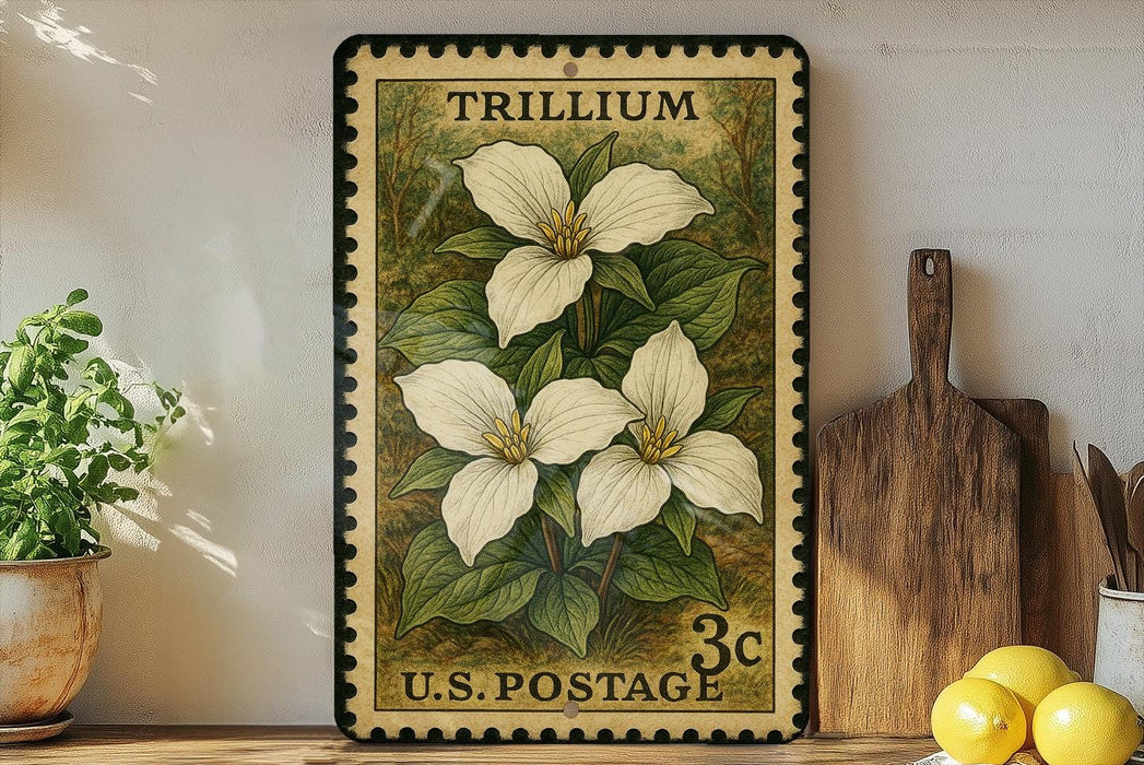 A vintage-style postage stamp featuring a white trillium flower, placed on a shelf next to a wooden cutting board and a potted plant.