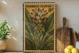 A framed illustration of a turmeric flower on a shelf, with a wooden cutting board and a potted plant nearby.