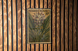 A vintage postage stamp featuring a turmeric flower is displayed on a wooden wall.