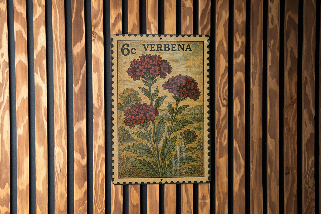 A vintage-style postage stamp featuring a floral illustration is displayed on a wooden wall.