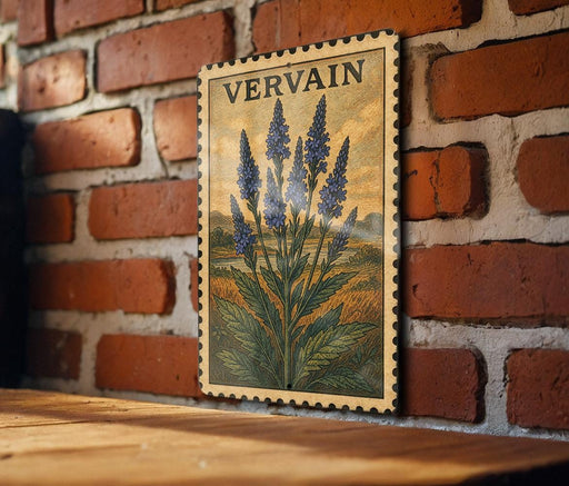 A framed illustration of blue flowers is hanging on a brick wall, with a wooden table below it.