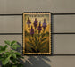 a framed illustration of purple flowers on a wall, with a plant to the left of the frame.