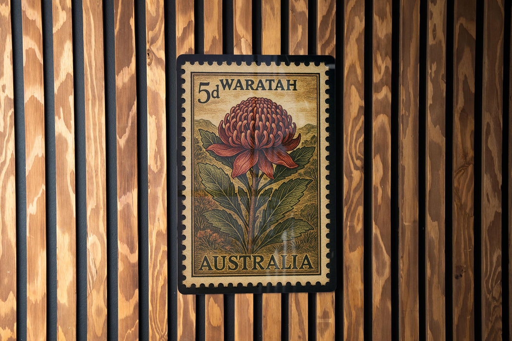 A 5d Waratah stamp from Australia, featuring a large red flower against a wooden background.