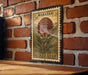 A vintage Australian postage stamp featuring a large red flower against a brick wall background.