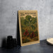 A 20c US postage stamp featuring a wild ginger plant with red flowers, placed on a table next to some black camera lenses.