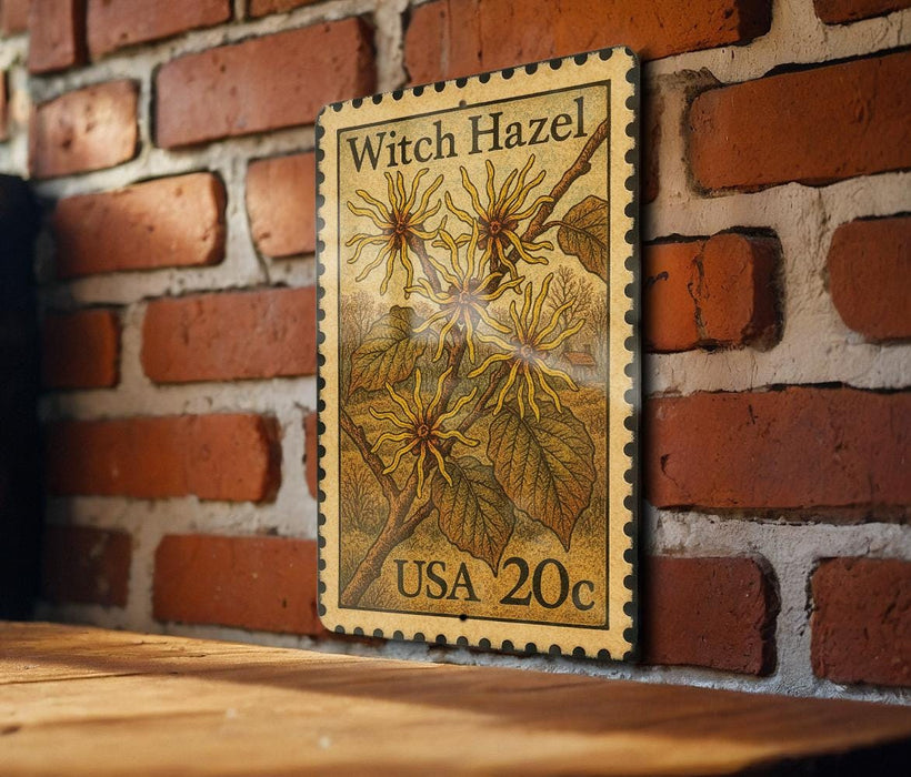 A wooden table with a brick wall in the background, featuring a vintage-style stamp depicting a plant with yellow flowers.