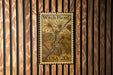 A United States postage stamp featuring a witch hazel plant, mounted on a wooden wall.