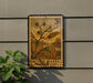 A vintage-style postage stamp featuring a plant with yellow flowers and green leaves, mounted on a wall next to a plant.