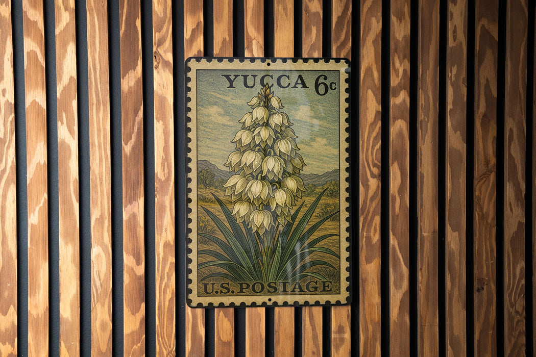 A vintage postage stamp featuring a detailed illustration of a flower on a wooden background.