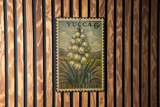 A vintage postage stamp featuring a detailed illustration of a flower on a wooden background.