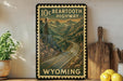 A vintage-style poster of the 10c Bear Tooth Highway in Wyoming, featuring a winding road surrounded by mountains and pine trees.