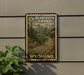A vintage-style sign for 10c Bear Tooth Highway in Wyoming, featuring a scenic mountain landscape with a winding road.