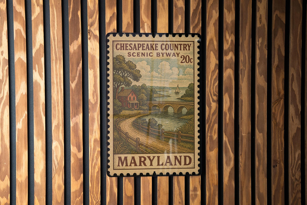 A framed postage stamp from Maryland, depicting a scenic countryside landscape with a river and bridge.
