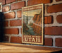 A vintage postage stamp depicting a scenic mountain landscape, with the text "FLAMING GORGE-UINTAS" and "SCENIC BYWAY UTAH" printed on it.