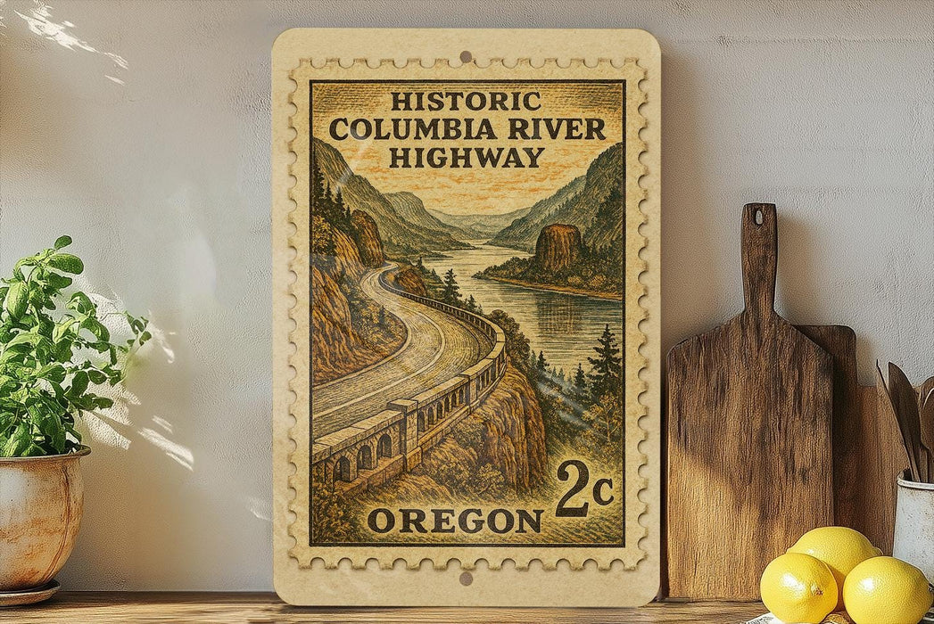 a wooden frame with a postage stamp design depicting a scenic highway in Oregon, surrounded by mountains and a river.