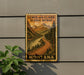 A vintage-style metal sign with a scenic mountain landscape and a winding road, mounted on a wall.