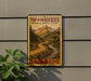A vintage-style sign for the Top of the Rockies National Scenic Byway in Colorado, featuring a scenic mountain landscape with a winding road.