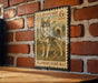 A U.S. postage stamp featuring an Alaskan Klee Kai dog, mounted on a brick wall.
