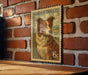 A vintage-style border collie postage stamp is displayed on a brick wall, with a wooden table below it.